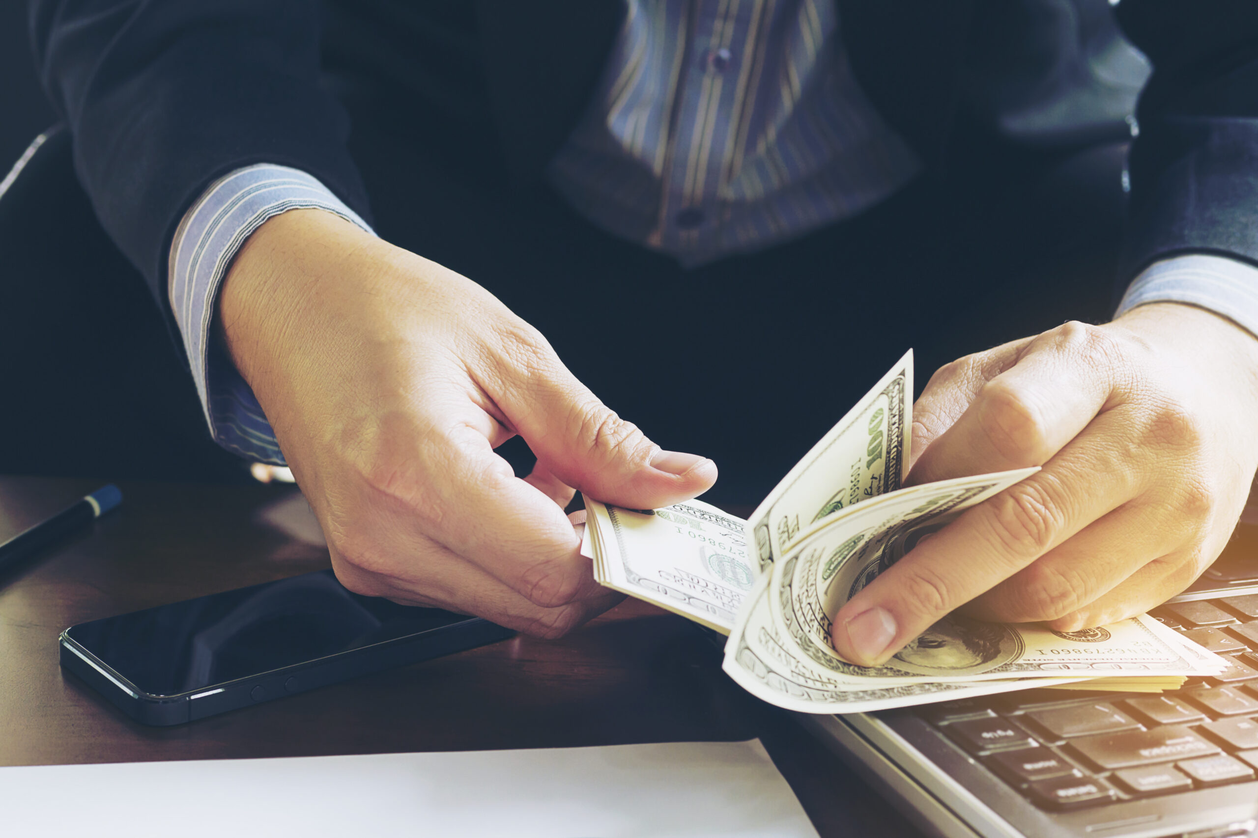 Business man counting dollar banknote - online business concept