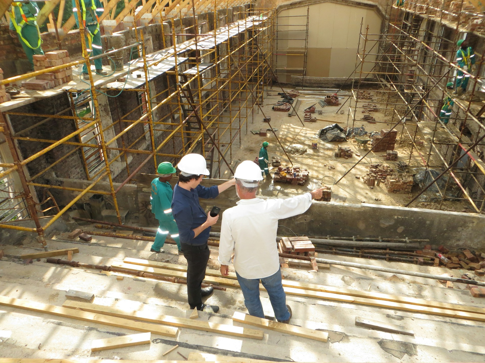 Two men discussing bookkeeping for construction companies.