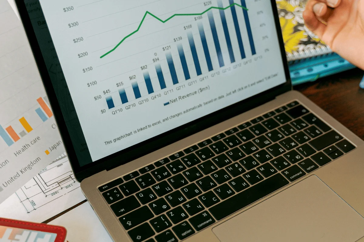 Close-up of a laptop screen showing financial analytics and a net revenue graph.