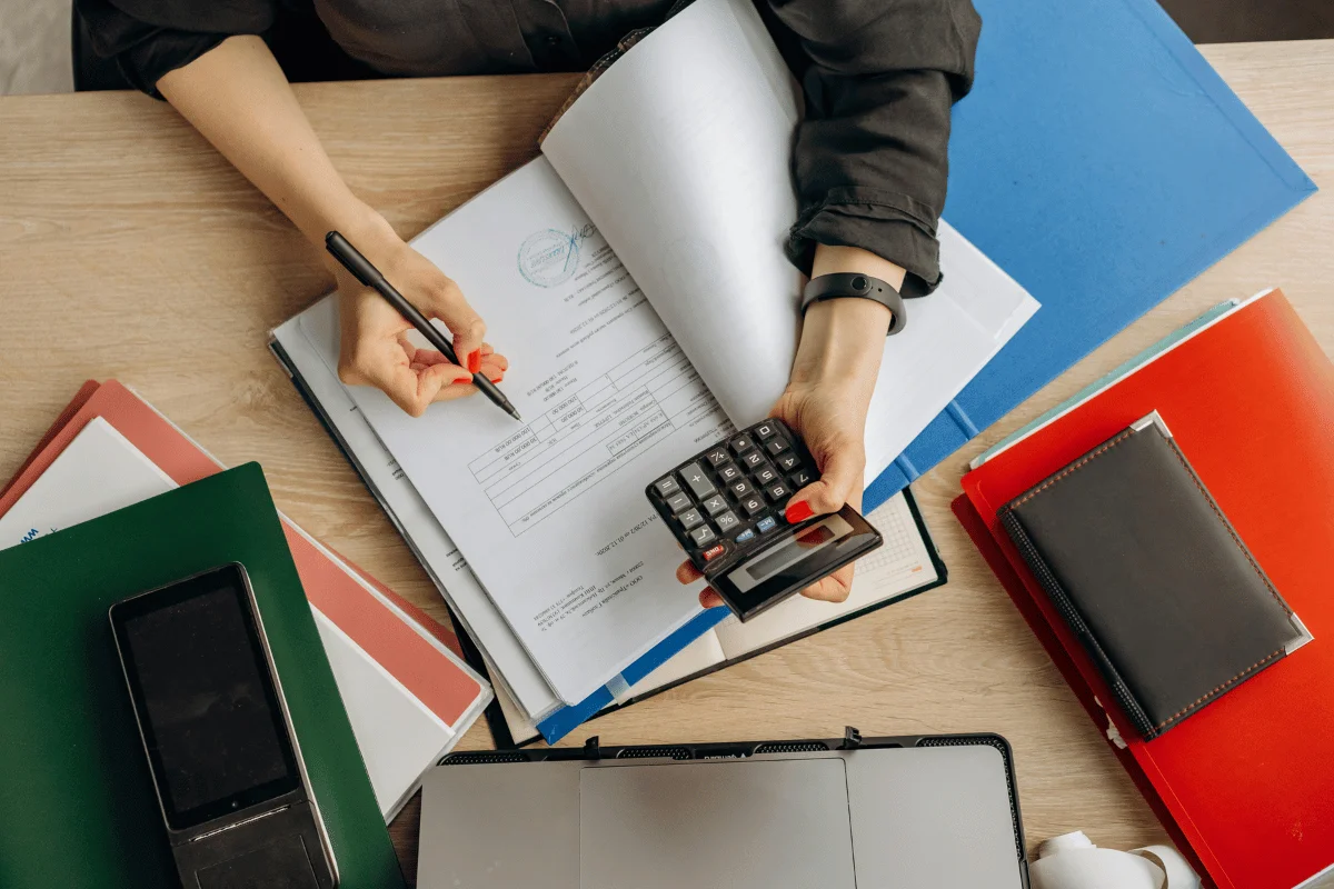 Business financial management with documents and a calculator. 